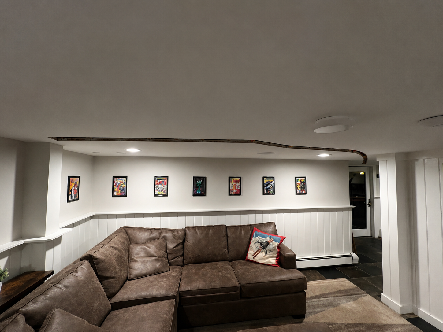 Concept render — basement electrical channel along the lounge wall
